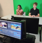 Two students recording the daily announcements