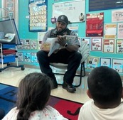 A police officer reading to a class