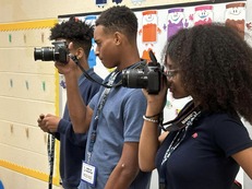 Students holding cameras