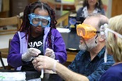 A student and teacher in a science lab