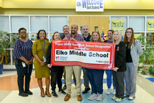 Elko Middle School staff holding up an award banner