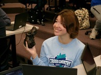 Student holding an artifact reproduction