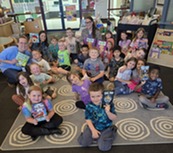 VDOE employee with classroom holding books