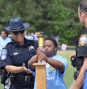 Police Officers engaged with students in a sport