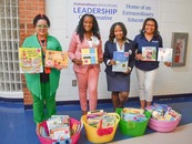 Faculty with books at the book drive