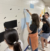 Students painting a mural