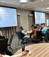 Business leaders, educators, and students at tables