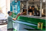 Students serving food from a food truck