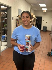 Tatianna with food items in a school kitchen