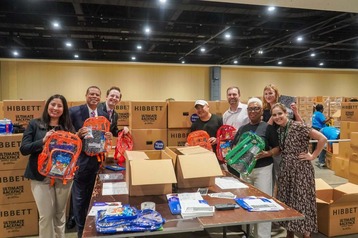 Secretary of Education and others with new backpacks
