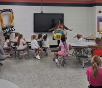 Jackie Johnson demonstrating bus safety to students