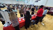 College fair with tables and students