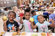 Students holding apples