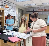 Teacher Mrs. McQuiddy with Chemistry students in class