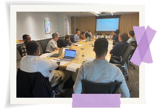 People sitting at table looking at screen