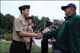 Navy Vets present challenge coins to JROTC at Navy 250th