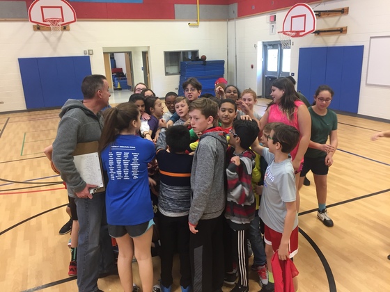 6th graders huddle at practice in preparation for staff vs. 6th grade basketball game.