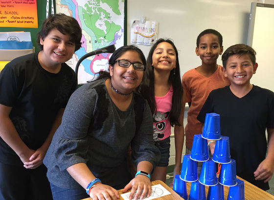 photo of students standing around cup game