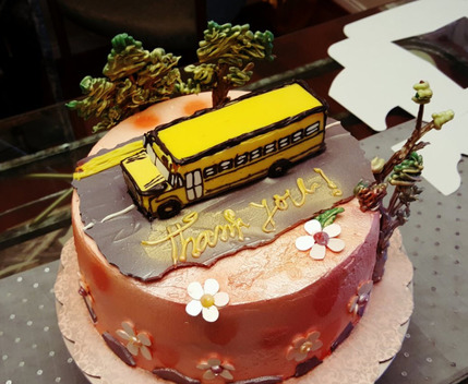 Elaborate cake with school bus on top