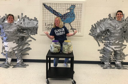 Principal Jackson, Mr. Beebe, and Ms. Heart from Lorton Station ES. Ms. Jackson and Mr. Beebe are duck-taped to the wall as part of a fundraiser.