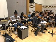 Music teacher performs with band and orchestra