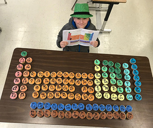 Wakefield forest student with periodic table of cupcakes.