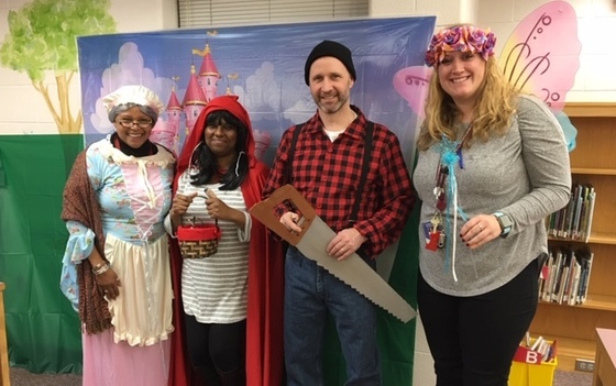 Photo of staff members in costume for the book fair.