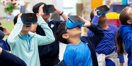 photograph of students looking through virtual reality goggles