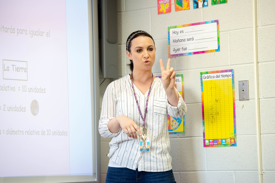 photograph of teacher holding up two fingers