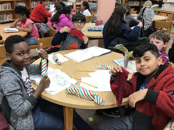 Kids in homework club enjoy gifts from Wolftrap ES.