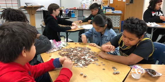Students counting change for the Pennies for Patients fundraiser