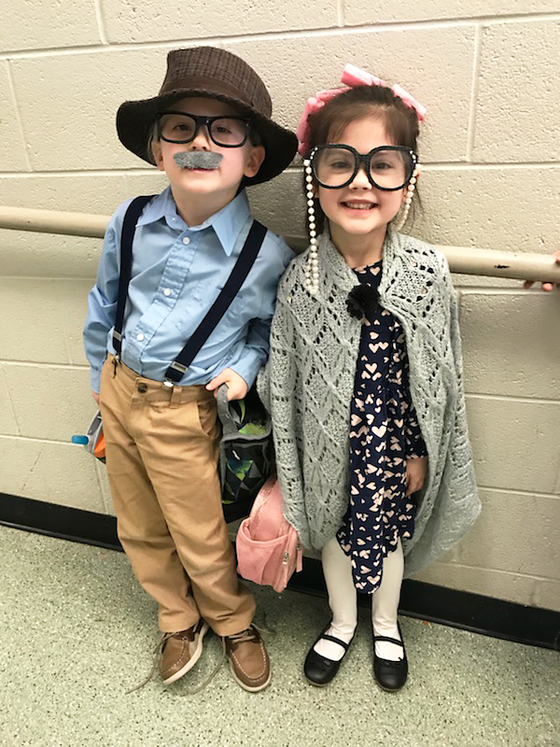2 kindergarten students dressed up as 100 year old man and woman