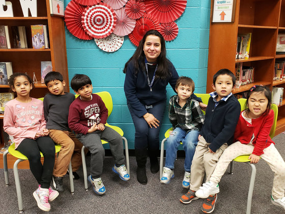 Miss G with her students in library