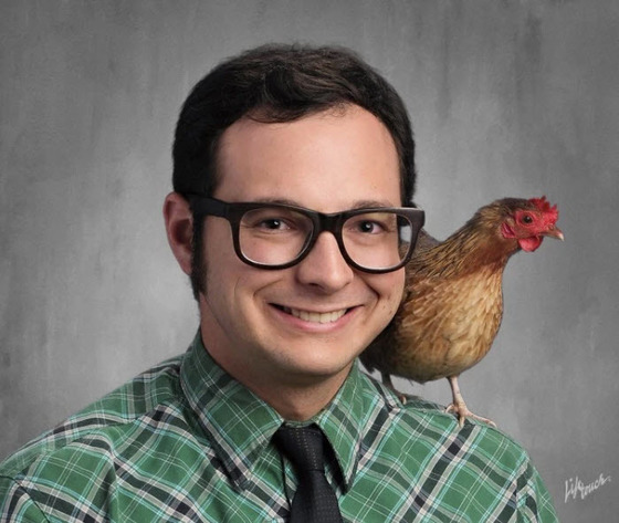 Twain MS Science Teacher Chris Kniesly in a photo with a chicken on his shoulder