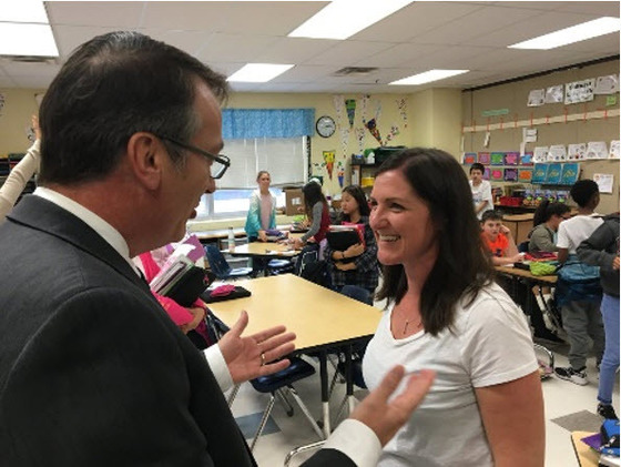 Dr. Brabrand conversing with a Navy teacher