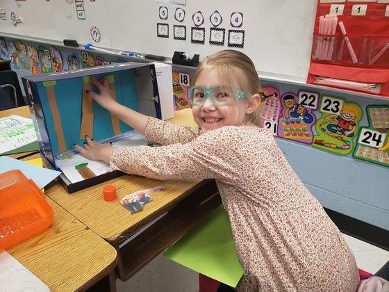 first grader building a diorama 