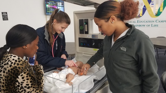 Picture of students with infant mannequin
