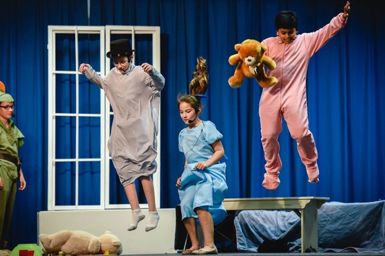 students performing on stage