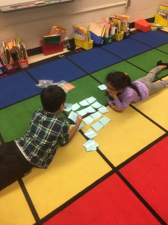 Photo of students on the rug playing math games