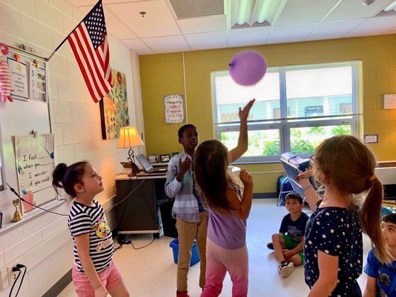 Second graders bounce a purple balloon in the counselor's office at Clermont.
