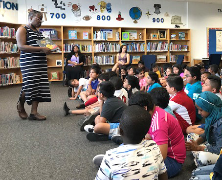 Photo of students listening to a guest speaker in the library