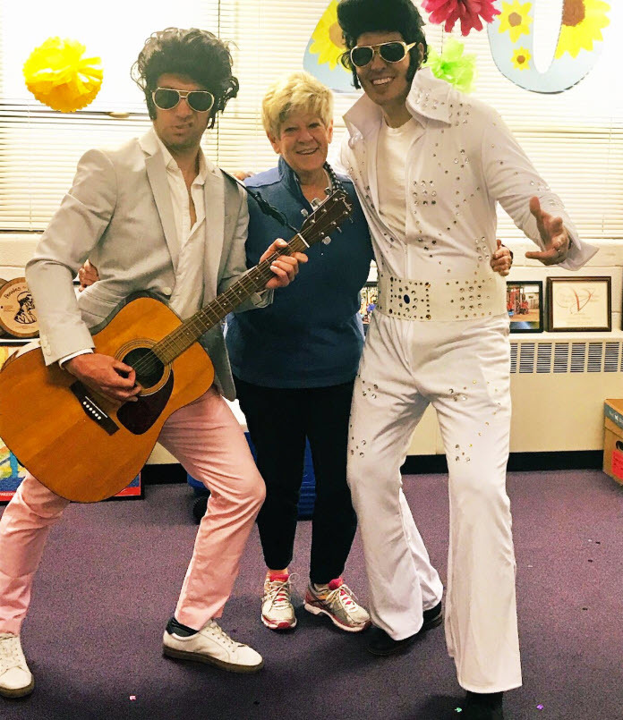 Freedom Hill ES Principal Scott Bloom, AP Joshua DeSmyter, dressed like Elvis as a surprise to Louan Hassinger, SIA.