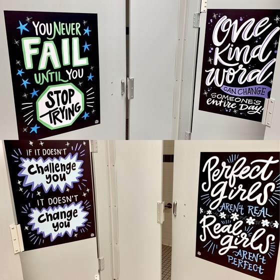Posters on bathroom stalls with inspirational quotes. 