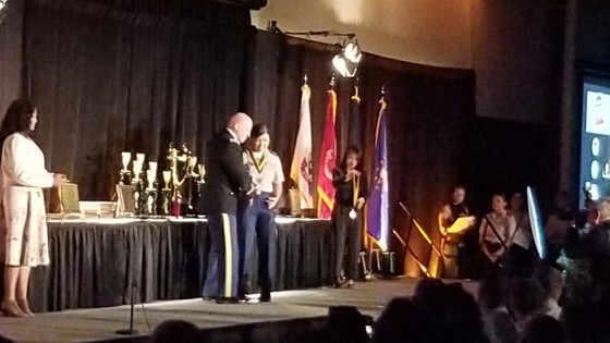 Elizabeth Tucker receiving a neck medallion 