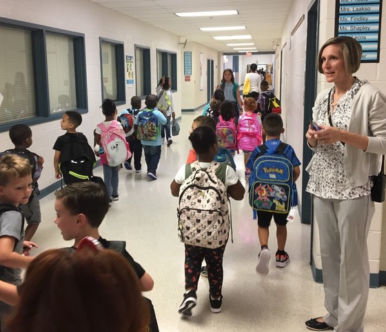 Principal greeting students