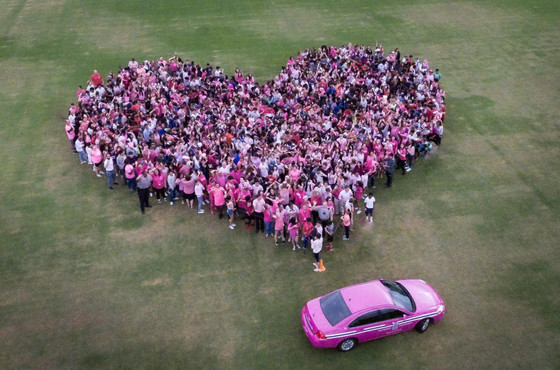 SCMS students and a staff made a heart to support breast cancer awareness.