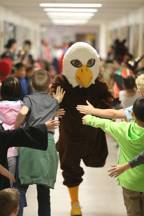 Mascot Ernie the Eagle runs through Clermont's halls high-fiving kids. 