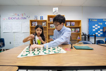 Photo of students learning to play chess