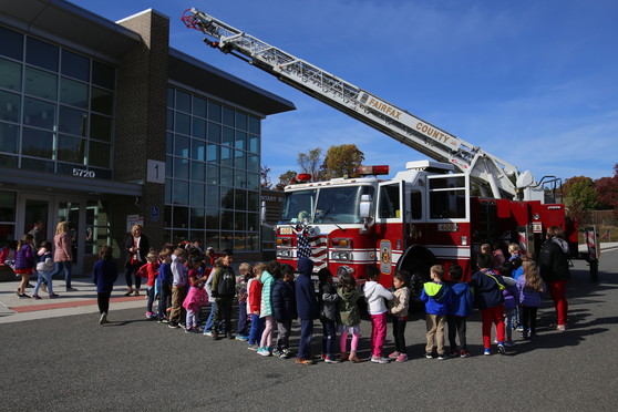 Students line up to visit a firetruck in Clermont's front lop. 
