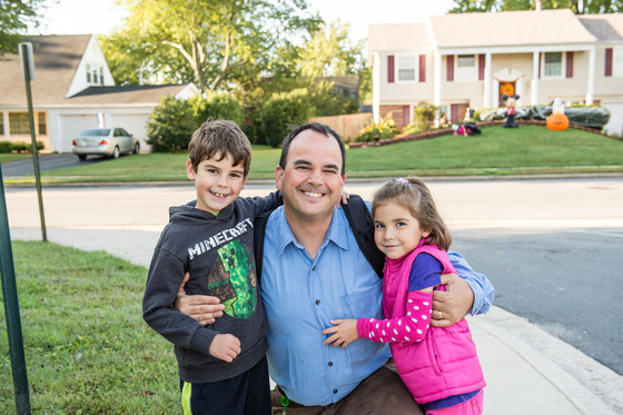 Father hugging children